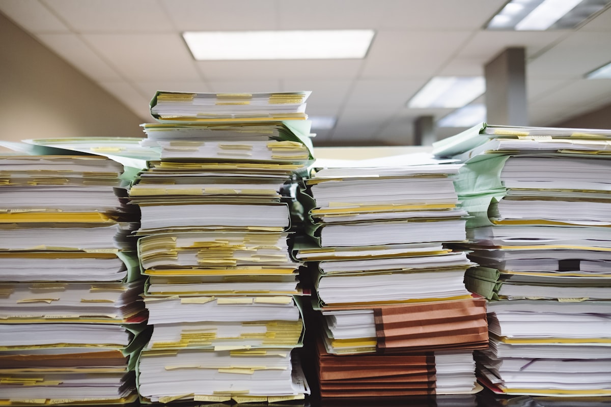 Stacks of documents representing compliance audit work